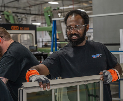 Windows USA manufacturing plant team member building a window