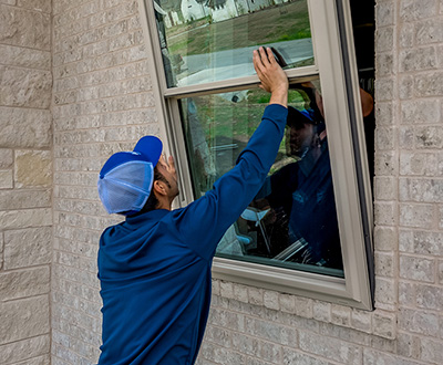 Windows USA installation technician fitting a window